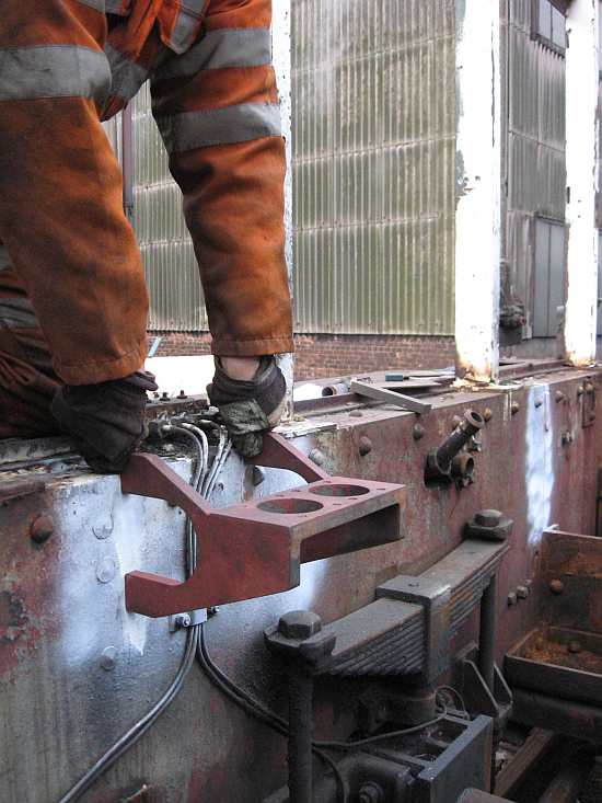 Andrew holds one of Beverley's rear mounting brackets in place