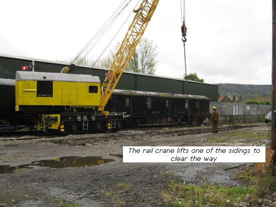 Rail crane lifts one of the siding panels