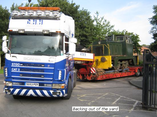 Truck and trailer with Grace aboard backing out of yard