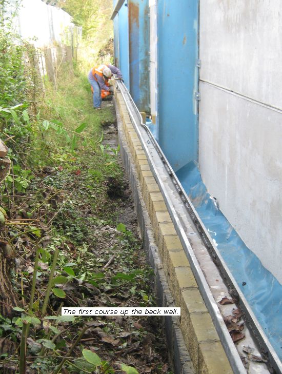 New shed - first course of blocks along back wall
