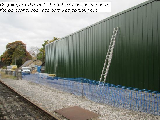 The first wall of green cladding with side door cut out