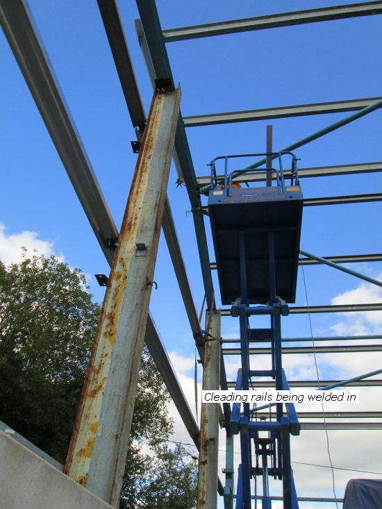 Cladding rails being welded in