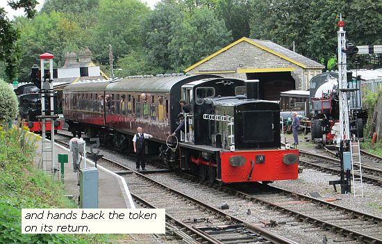 On its return "D2128" hands the token to the signal man on approach to Midsomer Norton