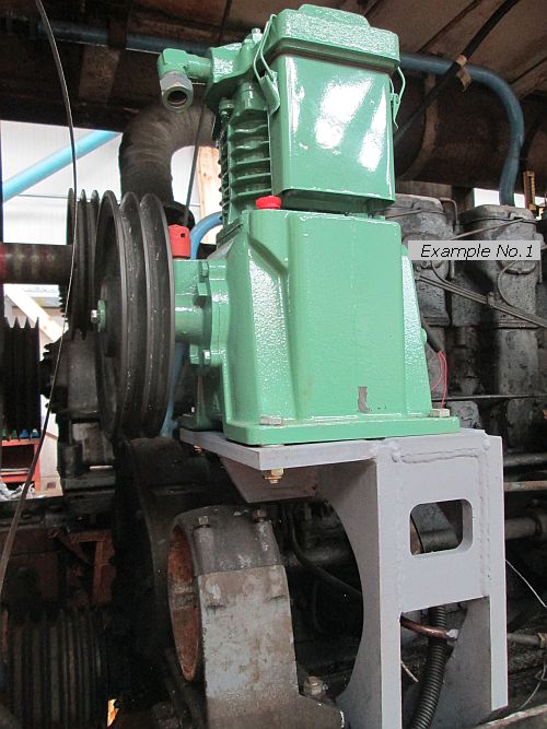 A brand new compressor squeezed in to a restricted space over a dynamo, showing custom base