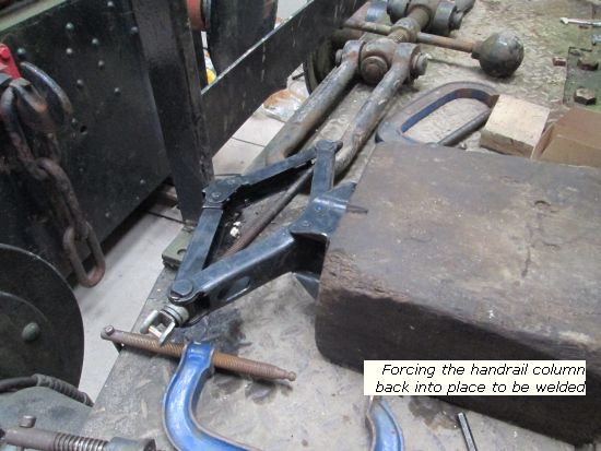 Charlie - forcing the handrail column back into place for welding